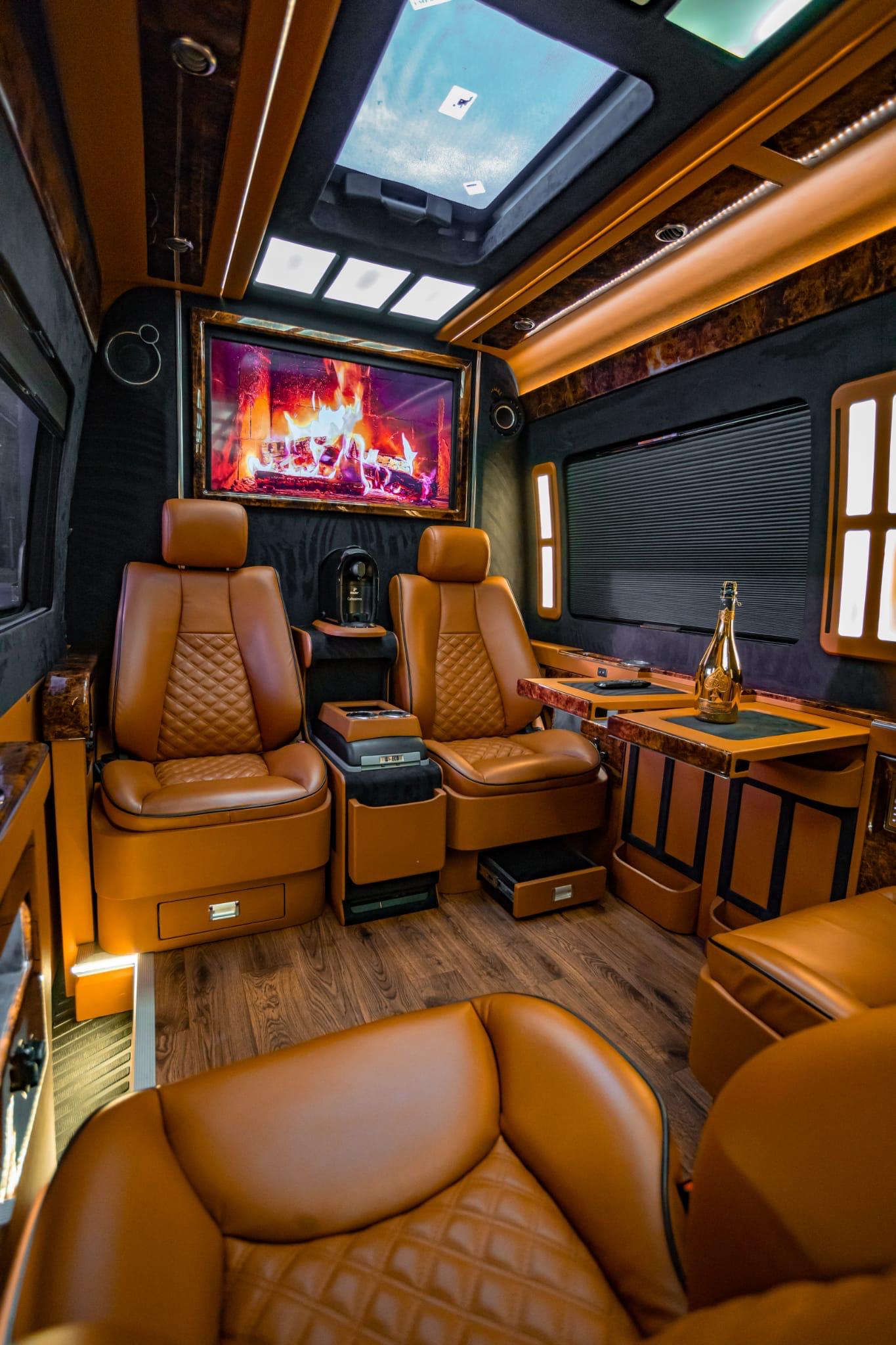 Panoramic view of executive van interior with four luxury leather seats