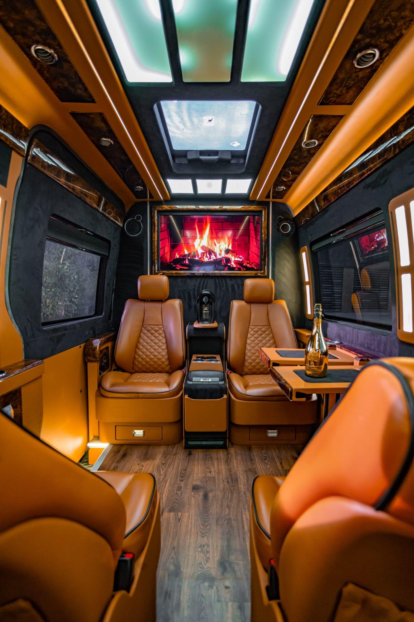 Executive van rear interior with facing leather seats and ambient lighting