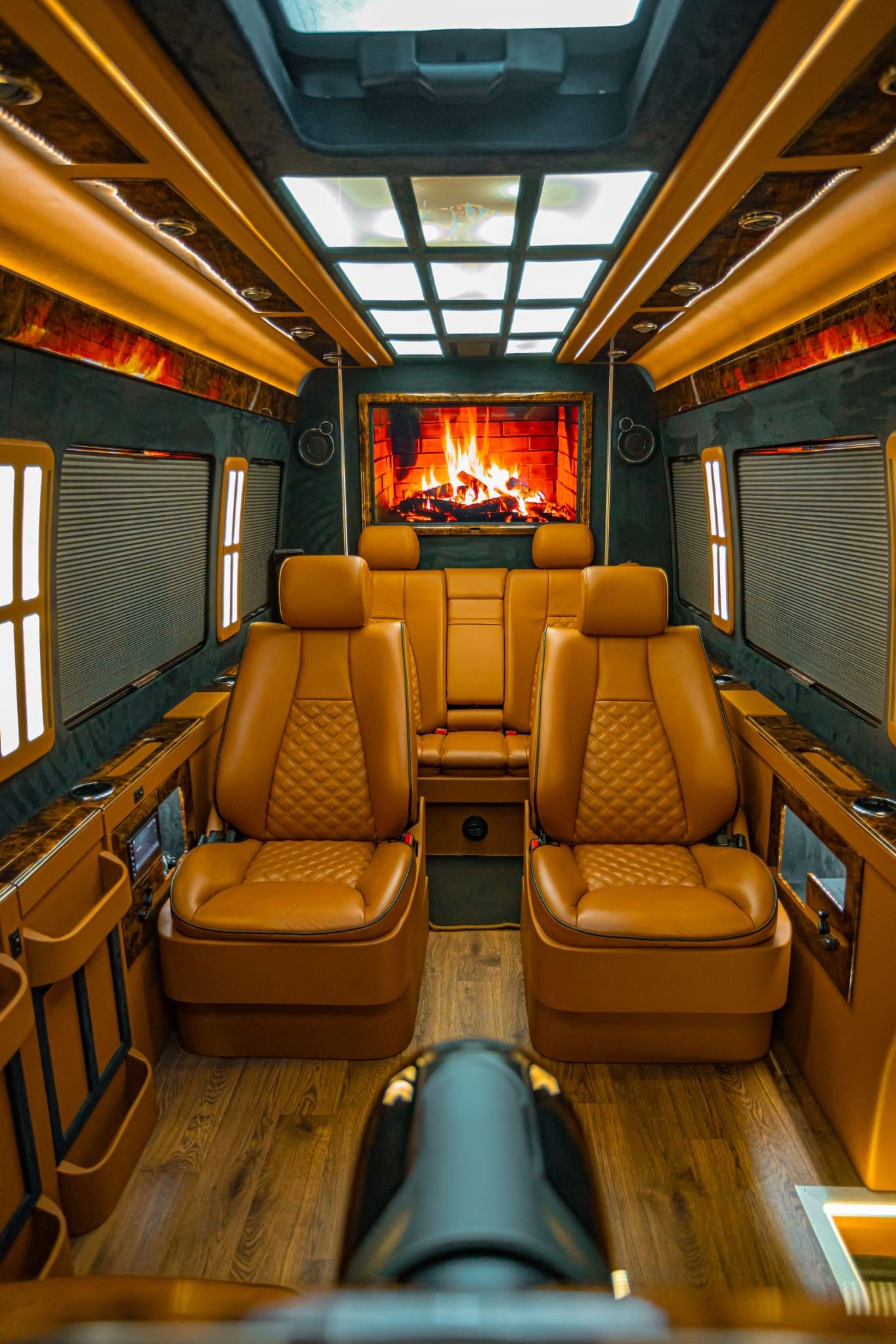 Executive van interior showing double rear seats facing entertainment screen